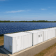 Solar farm with containerized battery storage system.