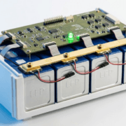  SunLith Energy LiFePO4 prismatic battery module with BMS circuit board mounted above the cells, showing temperature sensors and busbar connections — BMS for LiFePO4 batteries guide by Sunlith Energy