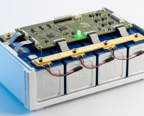  SunLith Energy LiFePO4 prismatic battery module with BMS circuit board mounted above the cells, showing temperature sensors and busbar connections — BMS for LiFePO4 batteries guide by Sunlith Energy