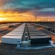 BESS grid-forming technology - SunLith Energy SunLith Energy BESS grid-forming technology — large utility-scale battery storage facility with power lines at dusk, Sunlith Energy