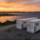 bess-oversizing-hero - SunLith Energy SunLith Energy Large BESS containers alongside a utility-scale solar farm illustrating BESS oversizing strategy
