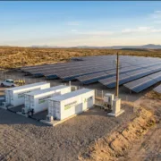 Microgrid BESS — Solar Plus Battery Storage Hero Image - SunLith Energy SunLith Energy Microgrid BESS system with solar panels and containerized battery energy storage units at a remote industrial facility.