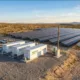 Microgrid BESS — Solar Plus Battery Storage Hero Image - SunLith Energy SunLith Energy Microgrid BESS system with solar panels and containerized battery energy storage units at a remote industrial facility.